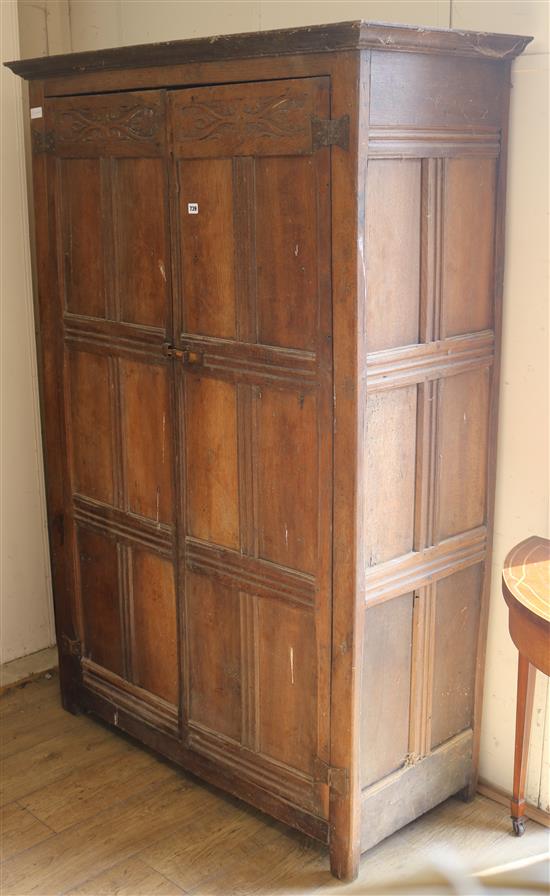 A panelled oak cupboard, H.184cm